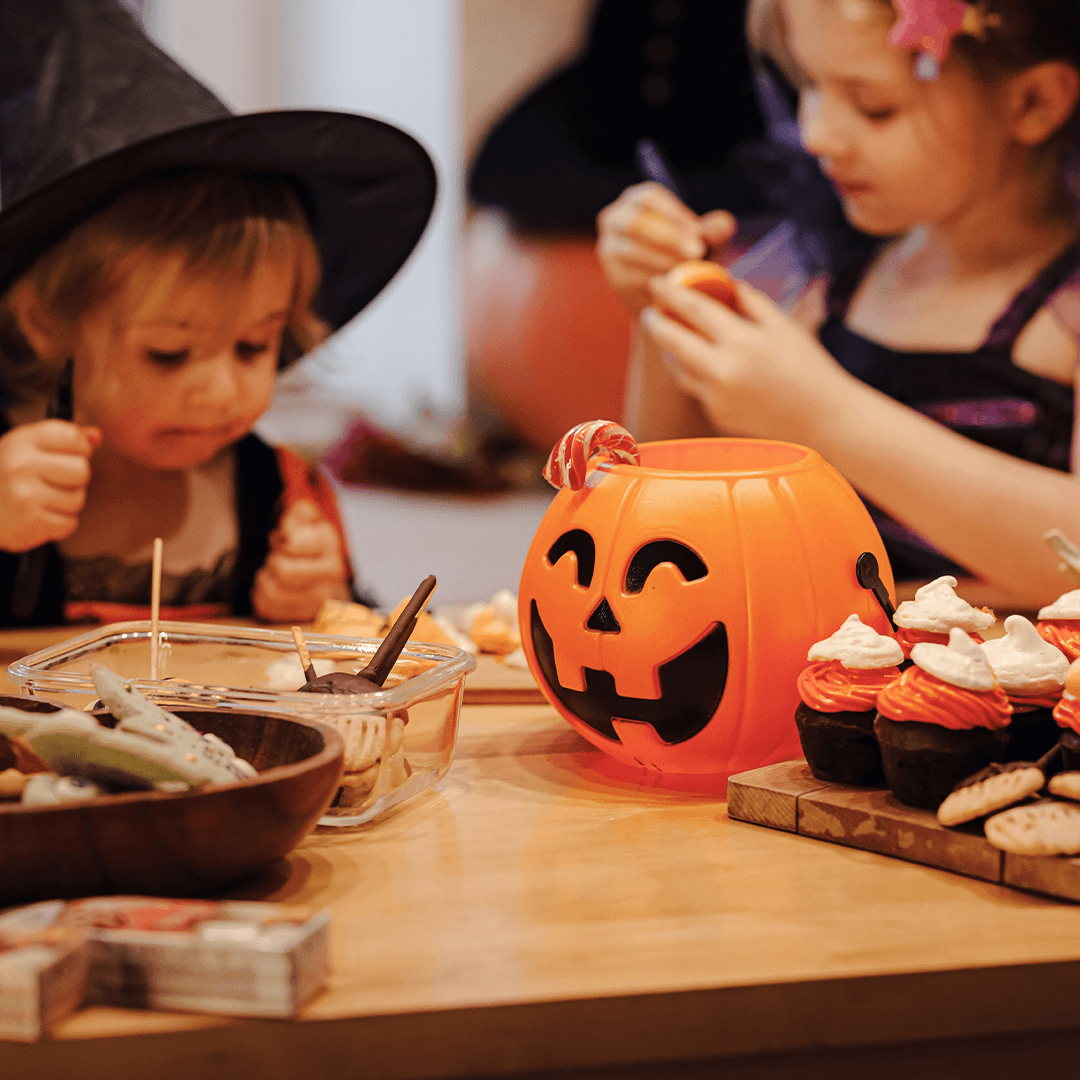Kids decorating Halloween treats together